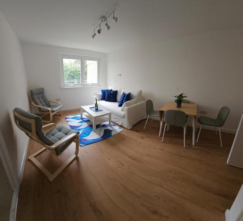 a living room with a couch and chairs and a table at Modern Flat near Central London! in London