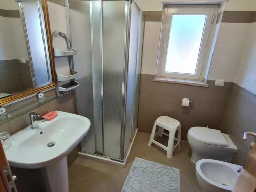 a bathroom with a sink and a shower and a toilet at Villa Brenda in Pizzo