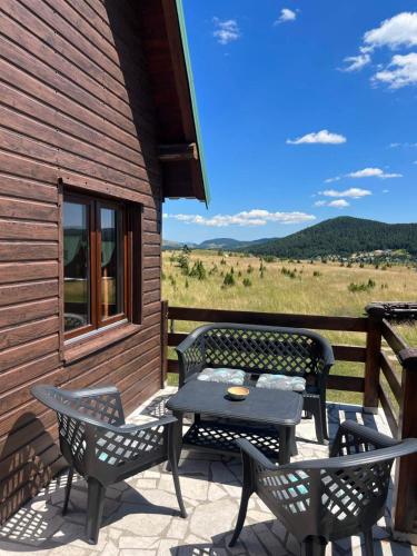 a patio with a table and chairs on a building at Zabljak Holiday in Žabljak