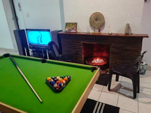 a living room with a pool table and a fireplace at MayBach Hills Palace Guesthouse in Saldanha
