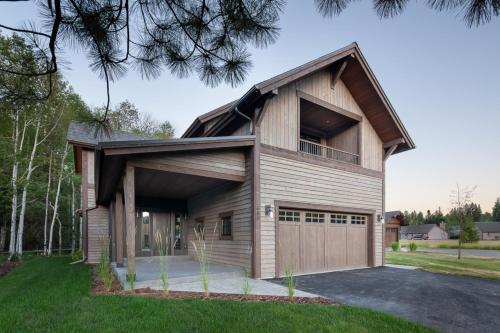 a house with a gambrel roof and a garage at Lodge at Whitefish Lake in Whitefish