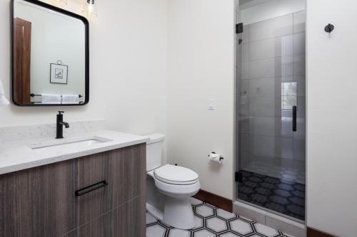 a bathroom with a toilet and a sink and a shower at Lodge at Whitefish Lake in Whitefish