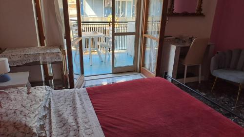 a bedroom with a bed and a view of a balcony at La Camera sul Mare in Maiori