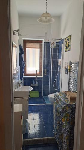 a bathroom with a sink and a toilet and a tub at La Camera sul Mare in Maiori