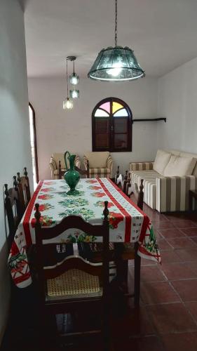 a living room with a table and a couch at Apartamento na praia do forte in Cabo Frio
