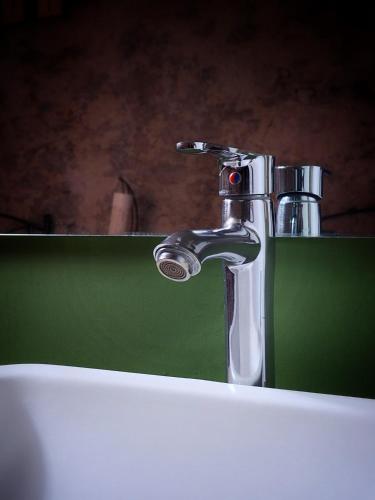 a close up of a bathroom sink with a faucet at Hotel el Descanso in Puebla