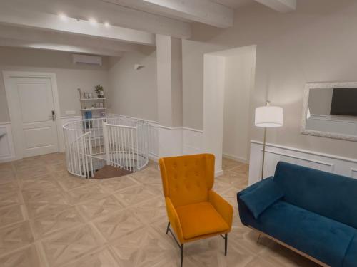 a living room with a blue couch and a chair at B&B Olea Tarsia in Tarsia