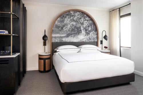 a bedroom with a large bed and a large window at Kimpton Cottonwood Hotel by IHG in Omaha