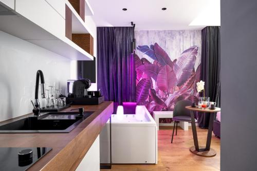 a kitchen with purple curtains and a table with chairs at Chamur Luxury Suites & Jacuzzi in Palermo in Palermo