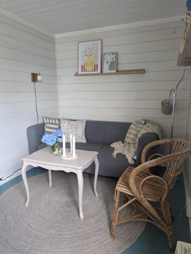 a living room with a couch and a table at Charming guest house with amazing view in Kvam