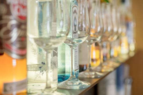 a row of wine glasses sitting on a shelf at Alpenhotel Krone in Pfronten