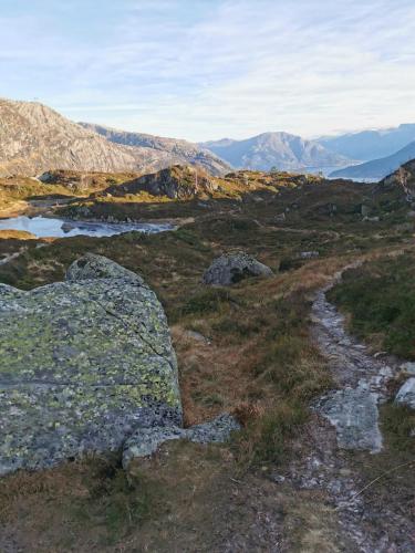 a view of a mountain with rocks and water at Charming guest house with amazing view in Kvam