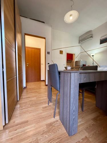 a kitchen with a table and chairs in a room at Grazia's Heaven in Trezzo sullʼAdda
