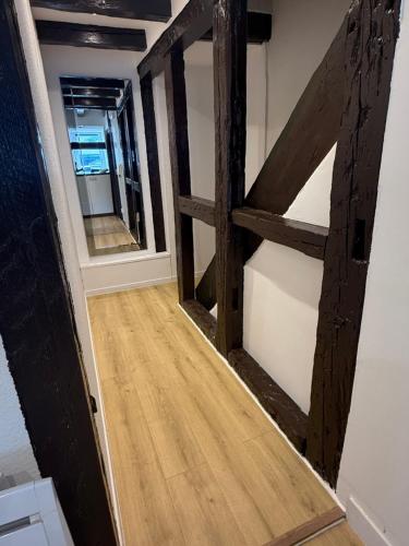 a hallway with a wooden door in a room at Duplex Le Léonor in Strasbourg