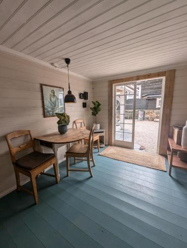 a dining room with a wooden table and chairs at Charming guest house with amazing view in Kvam