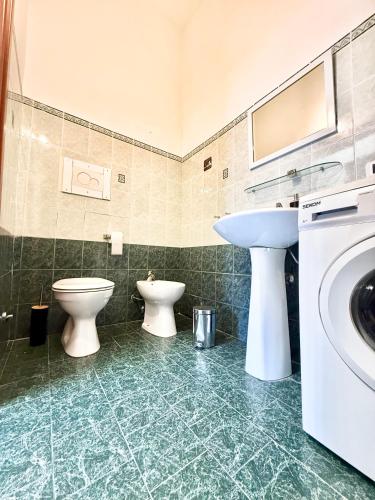 a bathroom with two toilets and a sink at Grazia's Heaven in Trezzo sullʼAdda