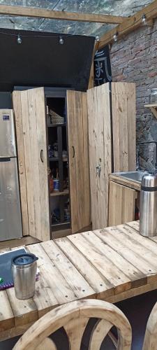 a wooden table in a kitchen with wooden cabinets at Mindfulness Glamping, Retiro de Yoga, Todo Incluido in Mexico City