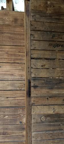 an open wooden door with a wooden wall at Mindfulness Glamping, Retiro de Yoga, Todo Incluido in Mexico City