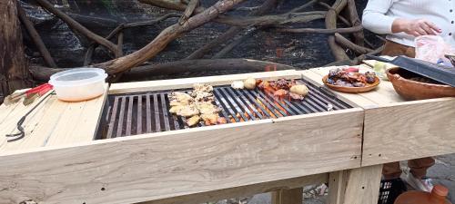 a table with a grill with food on it at Mindfulness Glamping, Retiro de Yoga, Todo Incluido in Mexico City