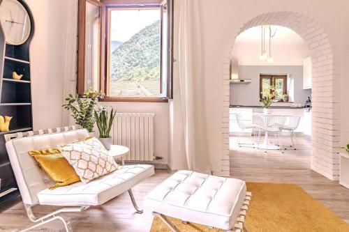 a living room with a white couch and a table at Blue Como Luxury APT #2 in Como