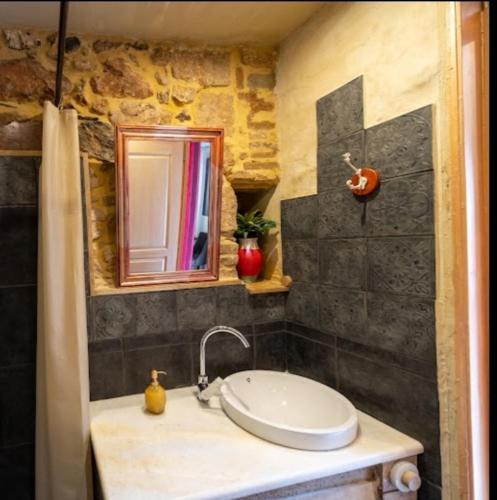 a bathroom with a sink and a mirror at Home4U Κερατέα apt5, just 17Km from airport in Keratea