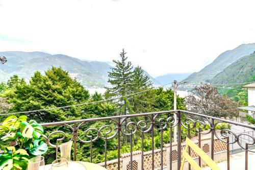 a balcony with a view of trees and mountains at Blue Como Luxury APT #2 in Como