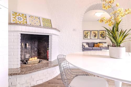 a living room with a white table and a fireplace at Blue Como Luxury APT #2 in Como
