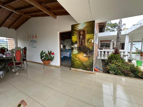 a living room with a large painting on the wall at Casa Lisieux- Jericó in Jericó