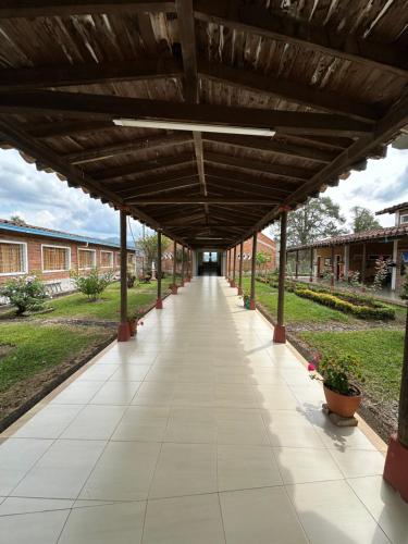 an empty hallway in a school building with a wooden ceiling at Casa Lisieux- Jericó in Jericó