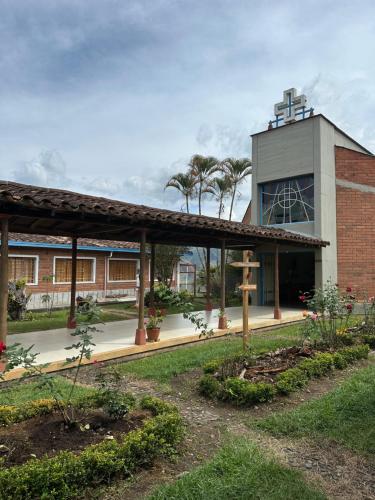 a building with a courtyard with trees and plants at Casa Lisieux- Jericó in Jericó