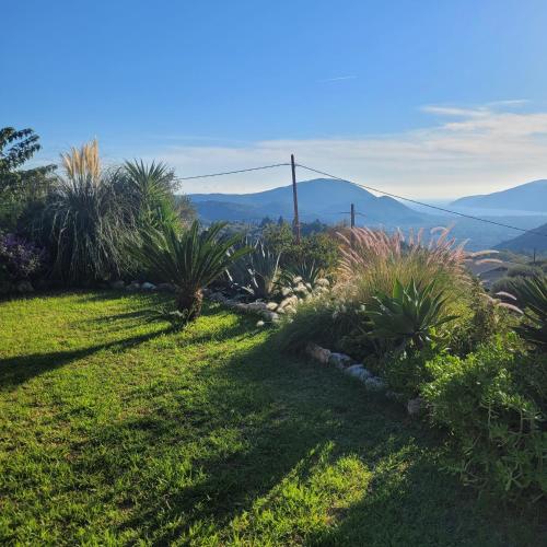 a garden with plants and a view of mountains at Villa Bakola in Sívros