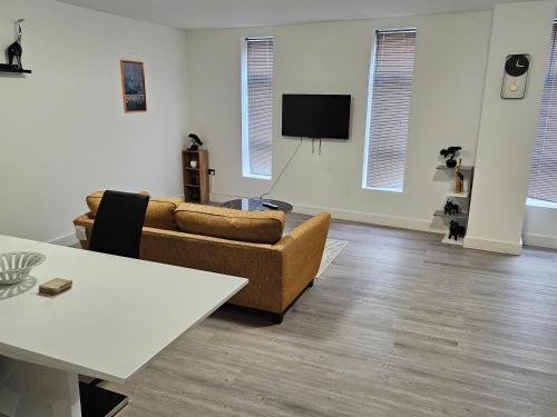 a living room with a couch and a table at Kingdom apartments in Wolverhampton