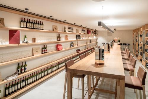 a wine store with a row of tables and chairs at Alpenhotel Krone in Pfronten