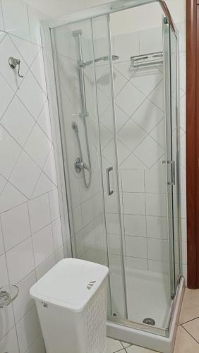 a shower stall in a bathroom with a toilet at Casa Vacanza Margherita in Assemini
