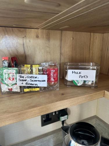 a wooden shelf with some food items on it at Duckpool 108 Bude in Bude