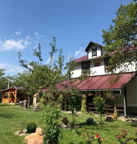 a large white house with a red roof at Casa BRA Viștișoara in Stațiunea Climaterică Sâmbăta