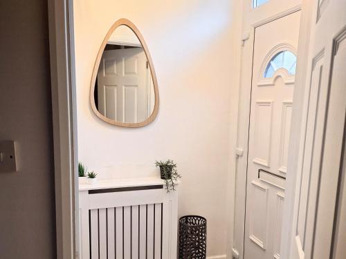 a mirror on a wall next to a door at Two-bedroom Cottage - Sandstone Garden Patio - Free Parking - Pets Welcome in Ingrow