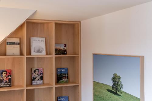 a book shelf in a room with a window at Alpenhotel Krone in Pfronten