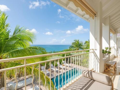 a balcony with a view of the ocean at Chez Paulette à distance à pied de la plage et piscine chauffée in Friar's Bay