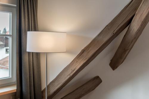 a lamp in a room next to a window at Alpenhotel Krone in Pfronten