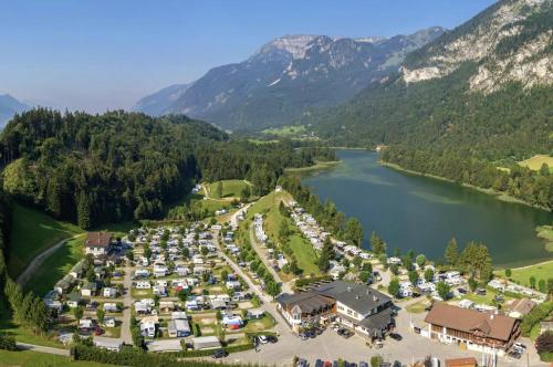an aerial view of a resort with a lake and mountains at PENTHOUSE N`1 - Stylish Apartment with Rooftop Whirlpool Access in Tyrol, presented by AlpenLuxus in Kramsach