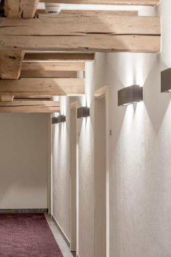 a wooden table with two lights on a wall at Alpenhotel Krone in Pfronten