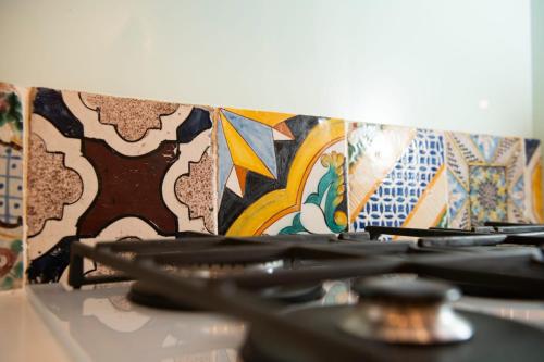 a stove top with a bunch of tiles on it at The Amalfi Blue Door in Amalfi