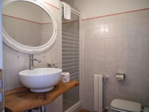 a bathroom with a sink and a mirror and a toilet at Masseria Del Crocifisso in Polignano a Mare