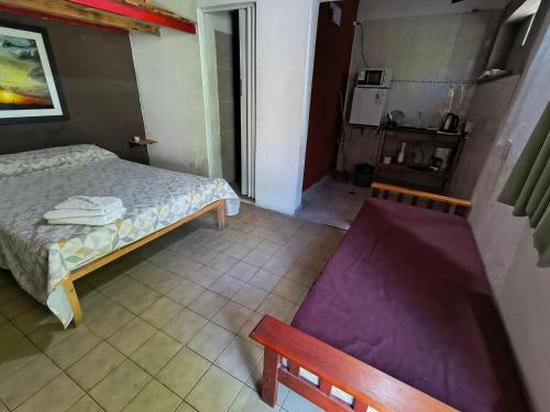 a small bedroom with a bed and a kitchen at Departamento PB 2 Centro Pileta in Formosa