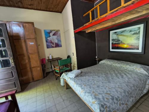 a bedroom with a bed and a dresser and a desk at Departamento PB 2 Centro Pileta in Formosa