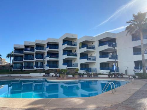 a large apartment building with a large swimming pool at Hermoso condominio frente al mar in San Carlos