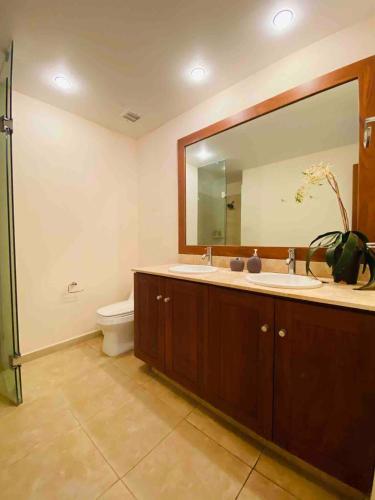 a bathroom with two sinks and a large mirror at Great Beachfront Amara Condo Ixtapa in Ixtapa