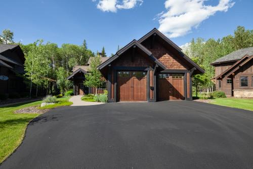 a driveway in front of a house with a garage at Lodge at Whitefish Lake in Whitefish