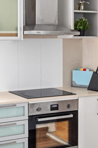 a kitchen with a stove top oven in a kitchen at Steps to Mall & Train - Eplore with Ease - Prime Location in Seven Hills - Shared Bathroom in Blacktown